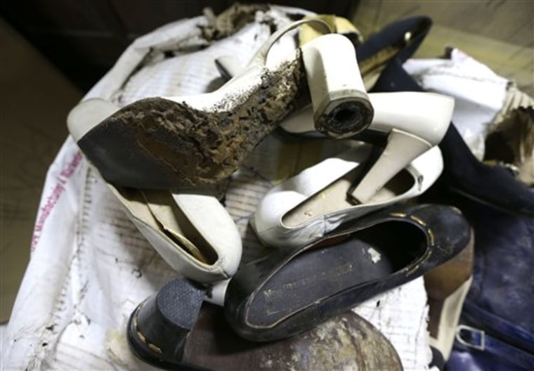 In this photo taken Thursday, a shoe once worn by flamboyant former Philippine first lady Imelda Marcos sits among equally-damaged shoes in a section of the National Museum in Manila, Philippines. (AP Photo/Bullit Marquez)